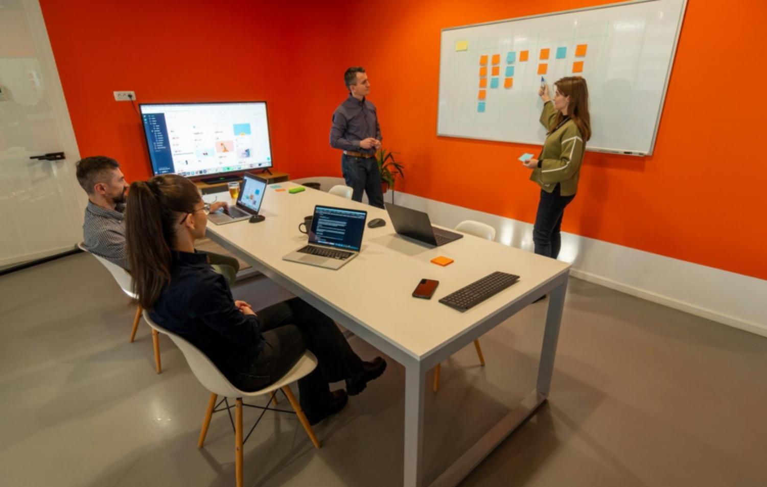 Collaborative venture building workspace with team members working on startup projects